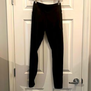 Pink high waisted ultimate leggings with mesh back on lower legs, side pockets,